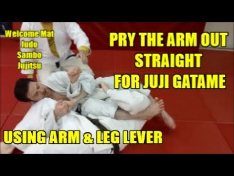 PRY THE ARM OUT STRAIGHT FOR JUJI GATAME USING THE ARM & LEG LEVER