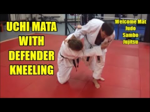 UCHI MATA WITH DEFENDER KNEELING